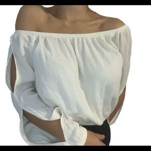 A white/beige top off the shoulders